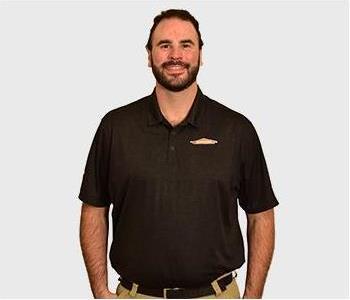 Technician in black t-shirt in front of white background